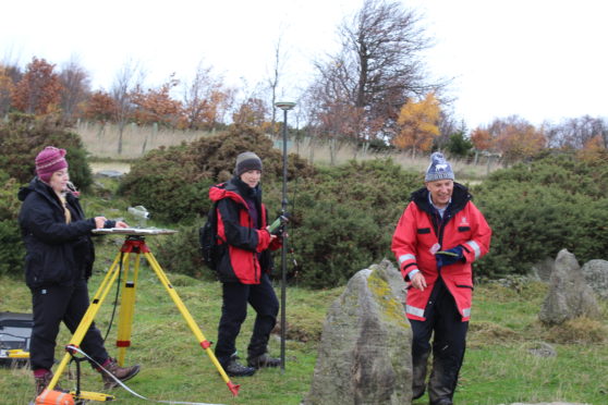 Archaeologists examining the stone circle.