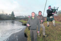 Piper Alistair Miller plays a tune as senior ghillie Geordie Doull prepares to toats the Thurso River, while East Yorkshire businessman Angus Oughtred stands by to cast the first fly. Looking on is River superintendant Tim Hawes. Photo: Robert MacDonald/Northern Studios.