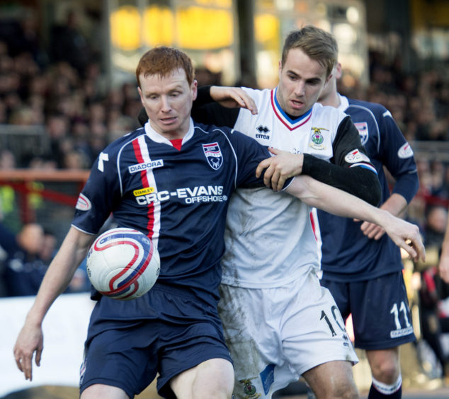 Ross County's Scott Boyd holds off Andrew Shinnie (right).