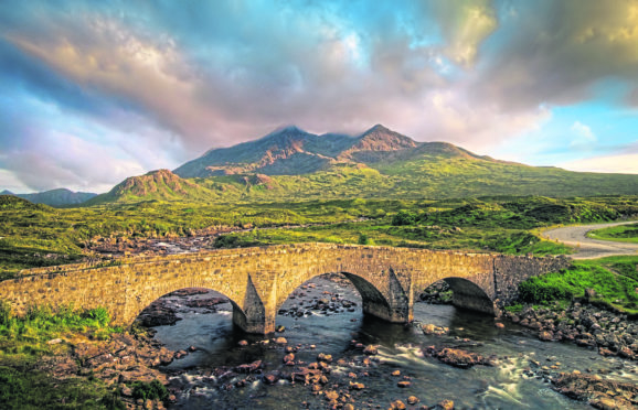 Sligachan Bridge and cloudy Black Cuillins in sunset light, Isle of Skye.