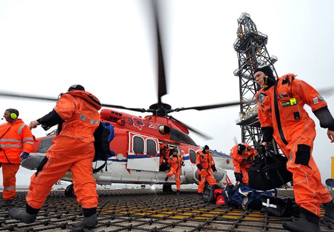 Offshore workers arrive on their platform by helicopter