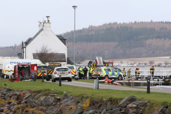 Police, fire and coastguard personnel during the major search operation near to Clachnaharry locks yesterday.