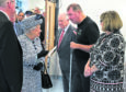 Queen Elizabeth II talks with patient and fundraiser Paul  Breen and his wife Liz, during a visit to Aberdeen Royal Infirmary.