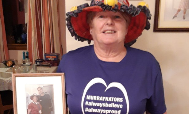 Joan MacGillivray holding the picture taken of her and Sir Andy Murray at the Davis Cup in 2015.