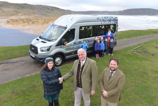 Katherine Wood of Farr High School receives new school bus from Tim Kirkwood and Andrew Adamson of Wildland Ltd