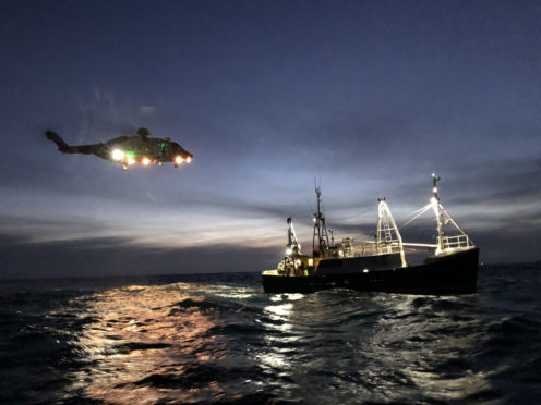 The coastguard helicopter with the fishing boat.