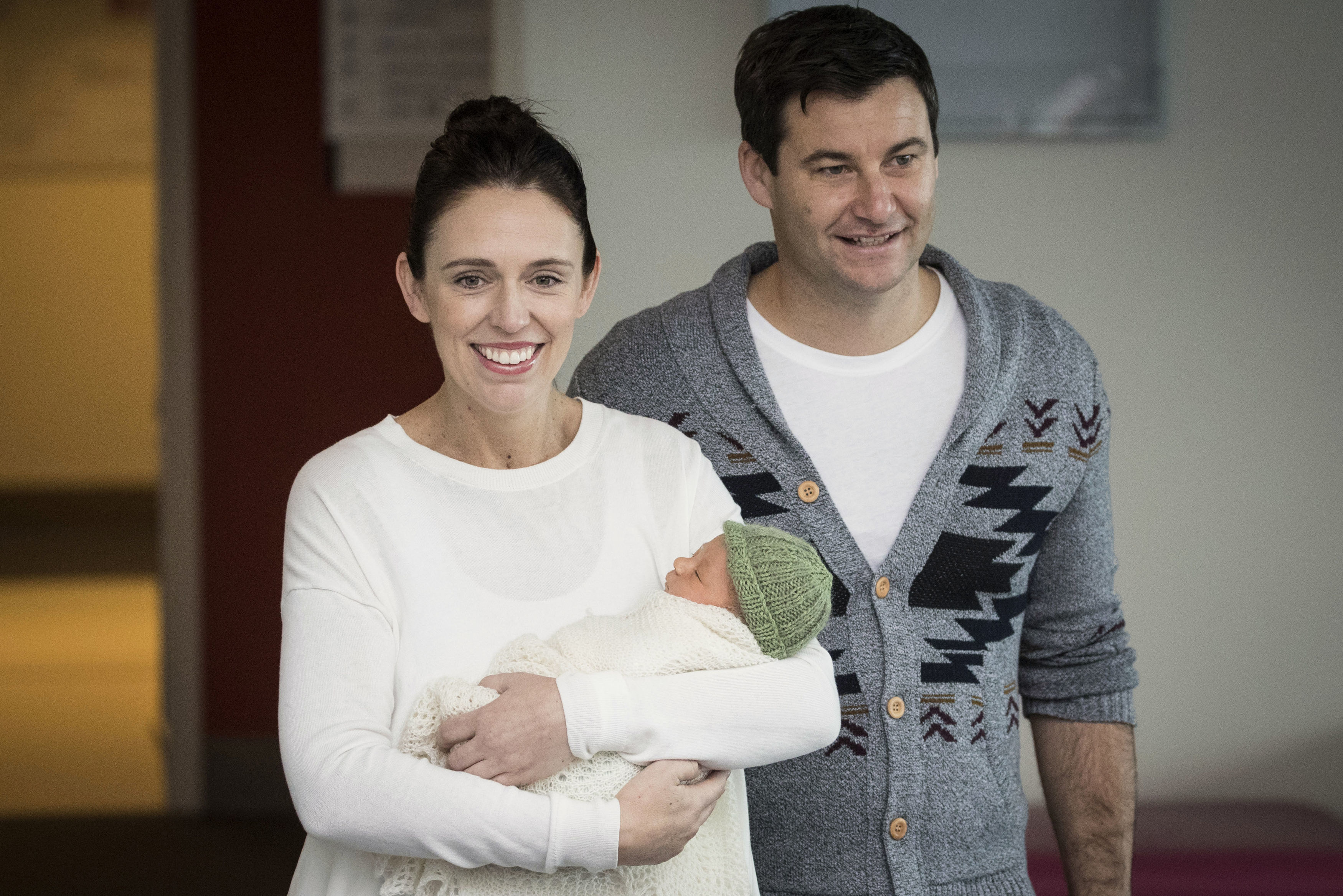 New Zealand Prime Minister Jacinda Ardern, left, with her partner Clarke Gayford, holds their newly born baby girl, Neve, at Auckland Hospital on Sunday, June 24, 2018. Ardern made her first public appearance on Sunday since giving birth to her daughter on Thursday. (Greg Bowker/New Zealand Herald via AP)