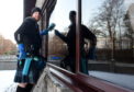 Pictured is Peter McKay washing a window. Peter is a window cleaner and has been wearing a kilt for the best part of a year to raise money for disabled friend and a spinal charity.
Pictured on 17/01/2019
Picture by Darrell Benns