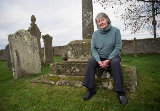 Iona Kielhorn, Chairperson of Lossiemouth Heritage Association at Kinneddar graveyard.
