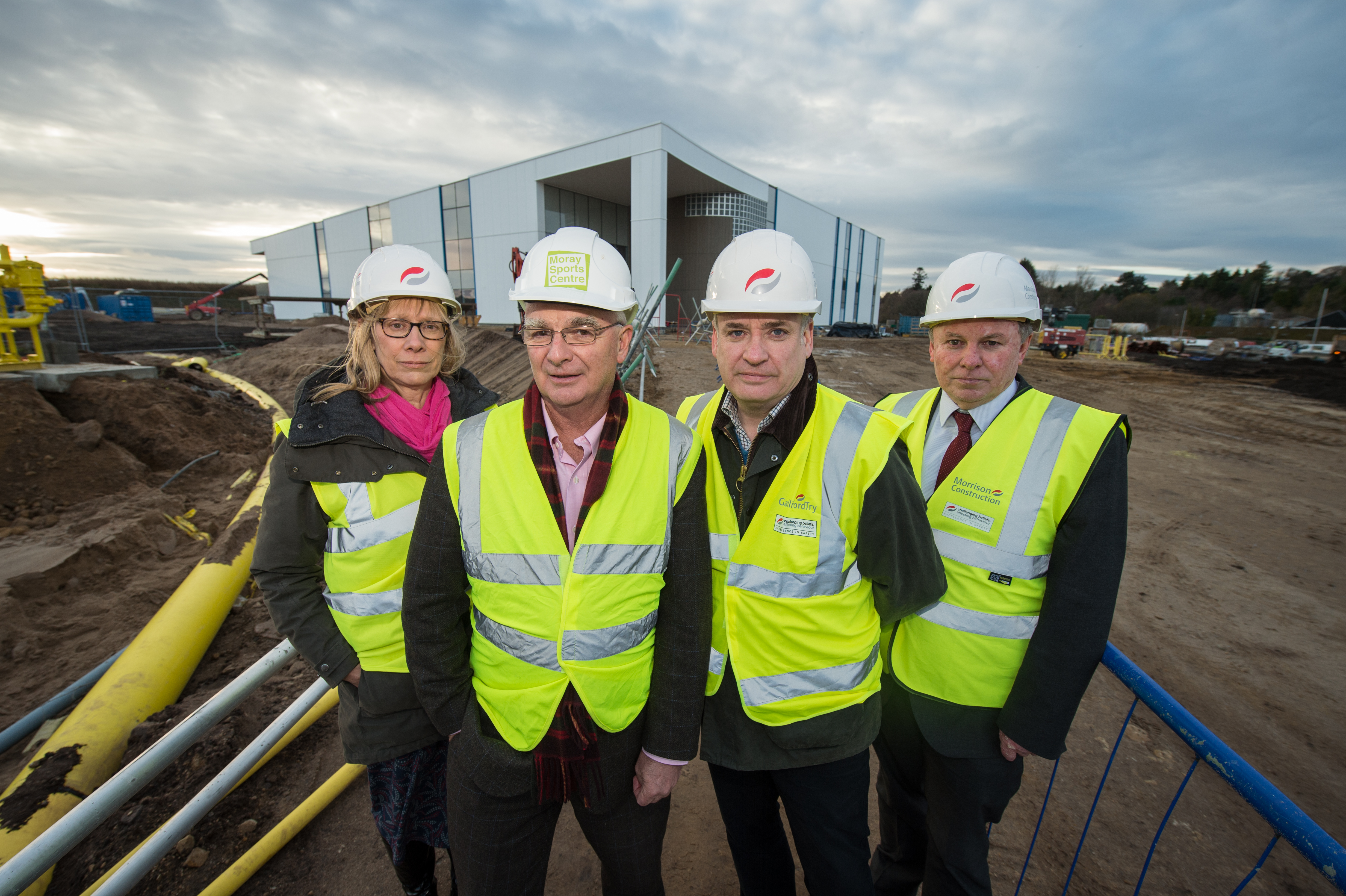 Jane Innes, trustee of Moray Sports Foundation, Sandy Adam, convener of Moray Sports Foundation, Moray MSP Richard Lochhead and Carl Gavine, operations manager of Moray Sports Centre, outside the under construction sports complex in Elgin.