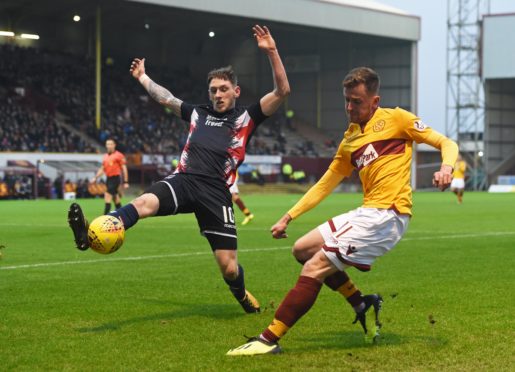 Motherwell's Elliott Frear (right) sees his cross blocked by Declan McManus