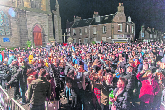People gather by the town clock in Thurso to bring in the new year in 2019.