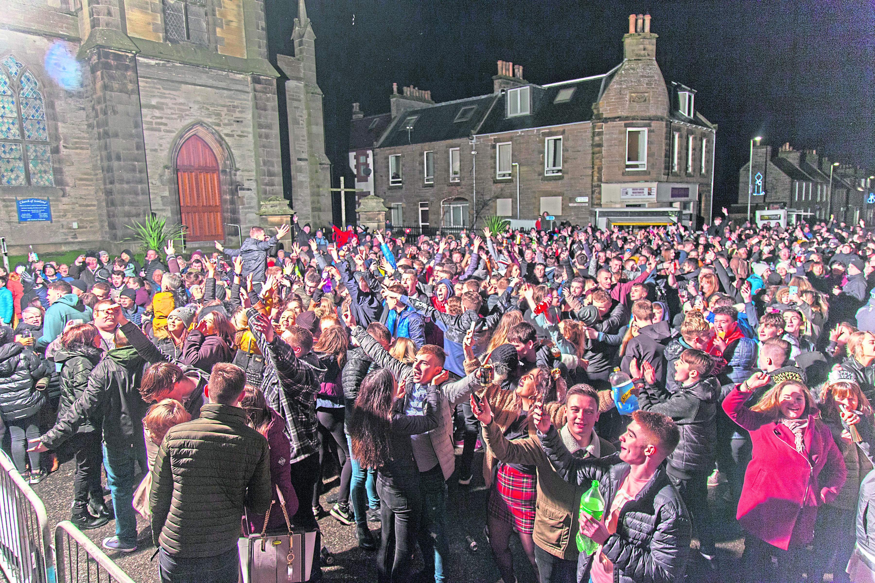 People gather by the town clock in Thurso to bring in the new year in 2019.