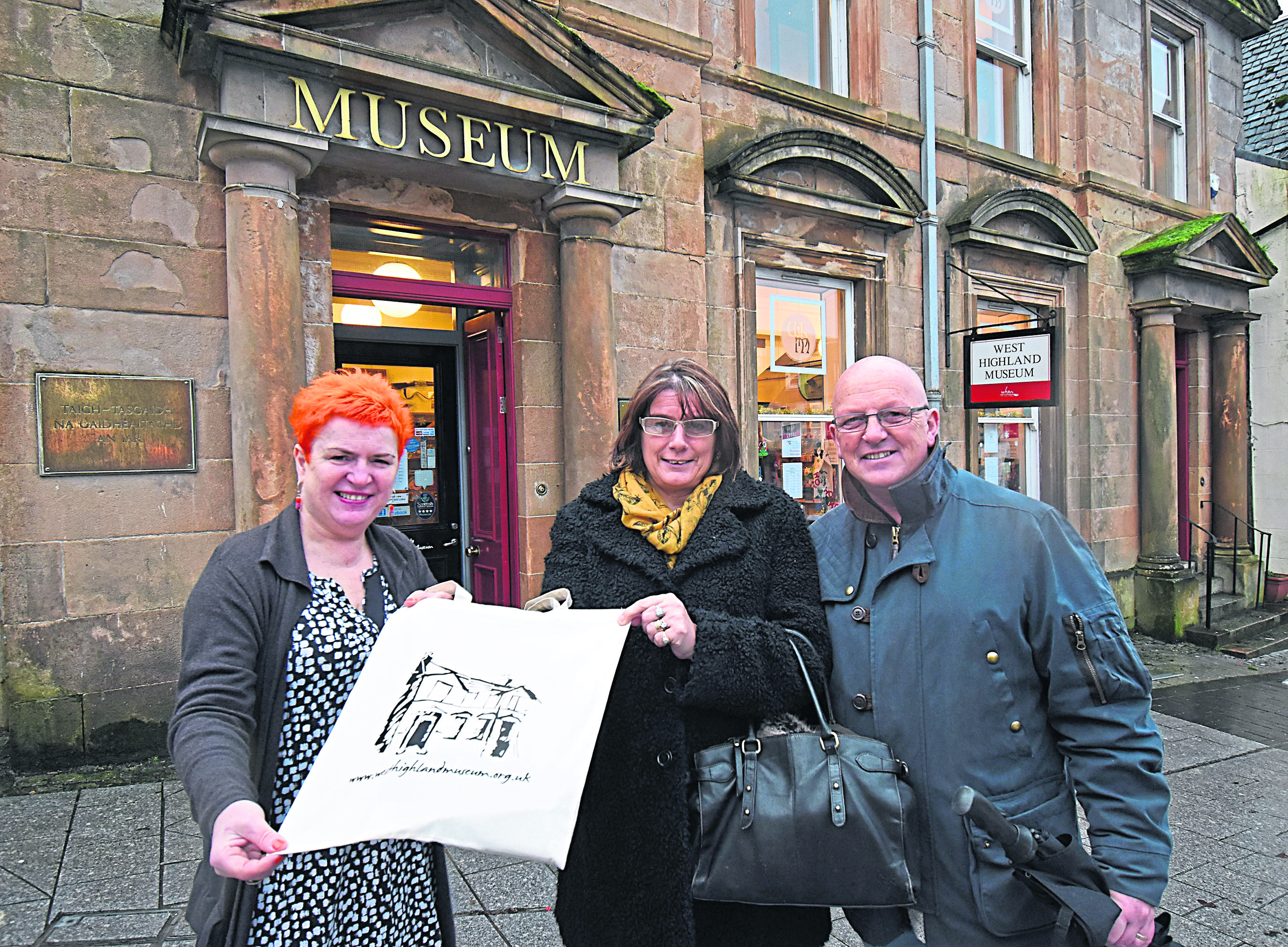 West Highland Museum Manager, Colleen Barker (left) presents a gift of museum mementos to Sarah Dunge ( her husband Mark), who became their 56,000th visitor in 2018.