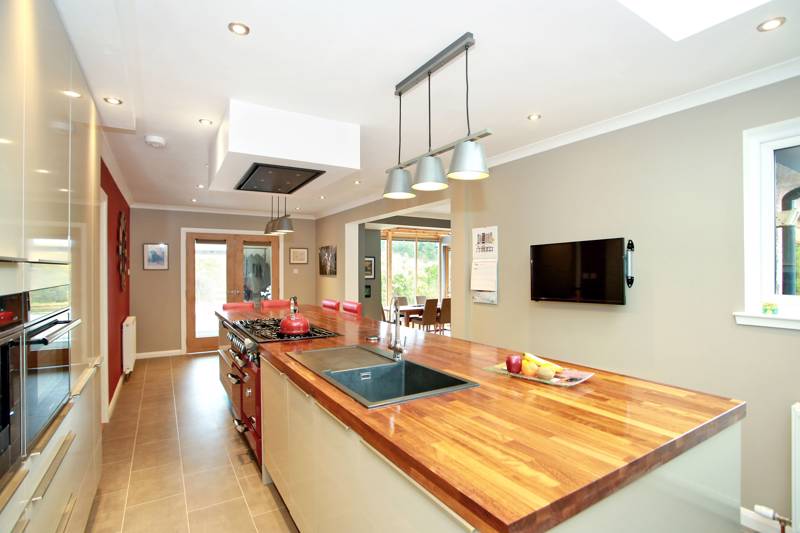 Kitchen: Boasts an exceptionally large work island  and wide selection of quality base and wall units