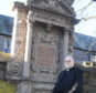 The Reverand Stephen Taylor is pictured with the Rickart's Memorial in St Nicholas Kirkyard before work on it's restoration begins.