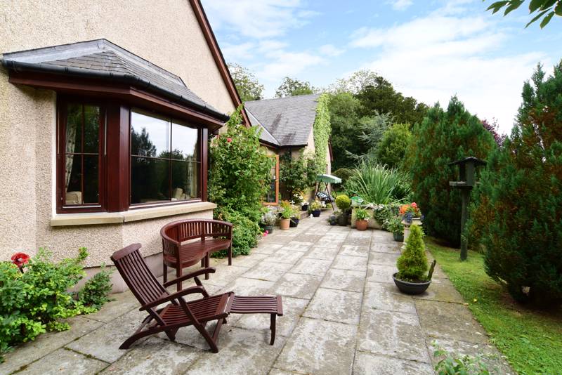 Rear Garden: The outdoor space also benefits from an orchard and patio area