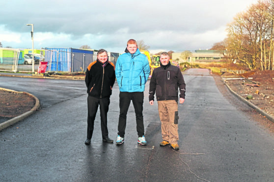 Community councillors Bill Harvey, Allan Strang and Sean MacIntyre examine the surface.