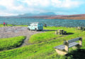Tourists and their campervan on the Kyle of Tongue with Ben Hope beyond.