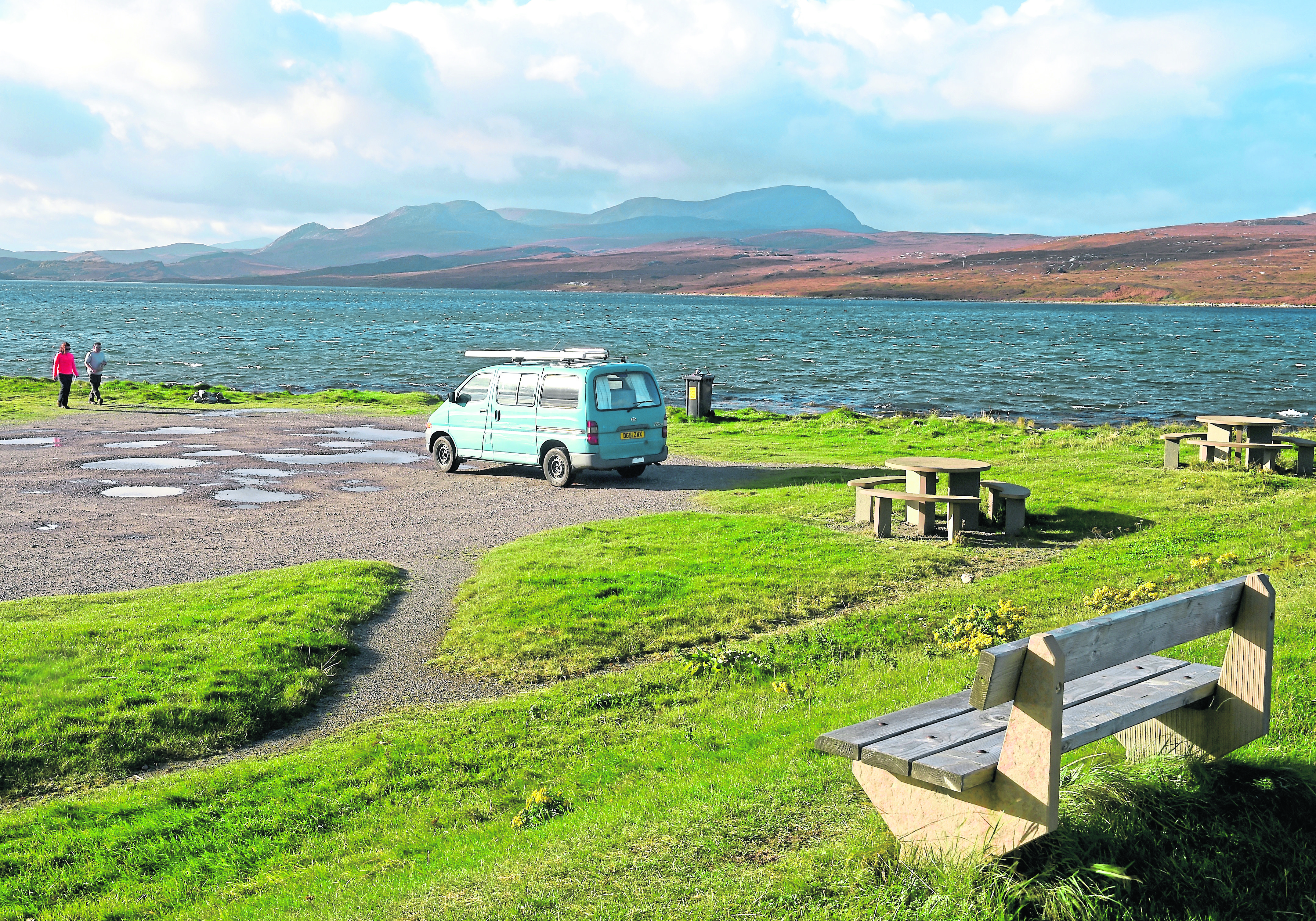 Tourists and their campervan on the Kyle of Tongue with Ben Hope beyond.