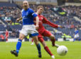 Queen of the South's Jim Thomson battles with Aberdeen's Darren Mackie.