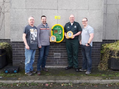 L-R: Dave Chapman, Ken Glass of Defibs for Moray, Ambulance technician Greg Winter and Willie Hardie with the new defibrillator installed at Elgin Town Hall