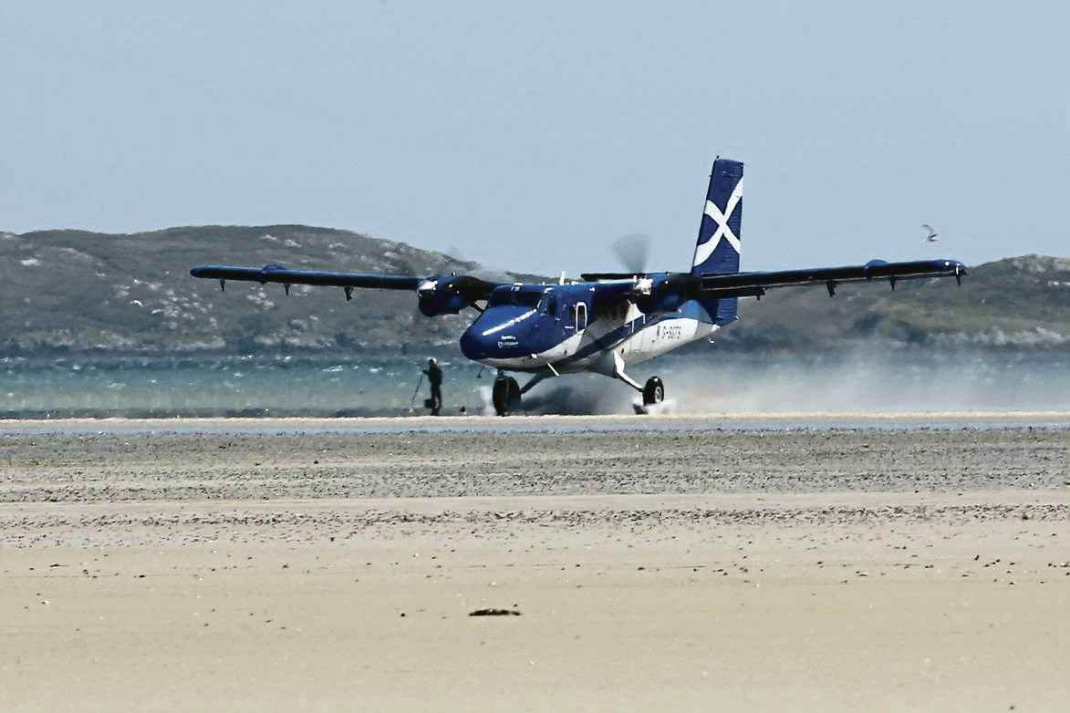 Loganair plane landing at Barra Airport