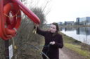 Torry councillor Catriona Mackenzie inspects the frayed rope on the River Dee lifebelt
