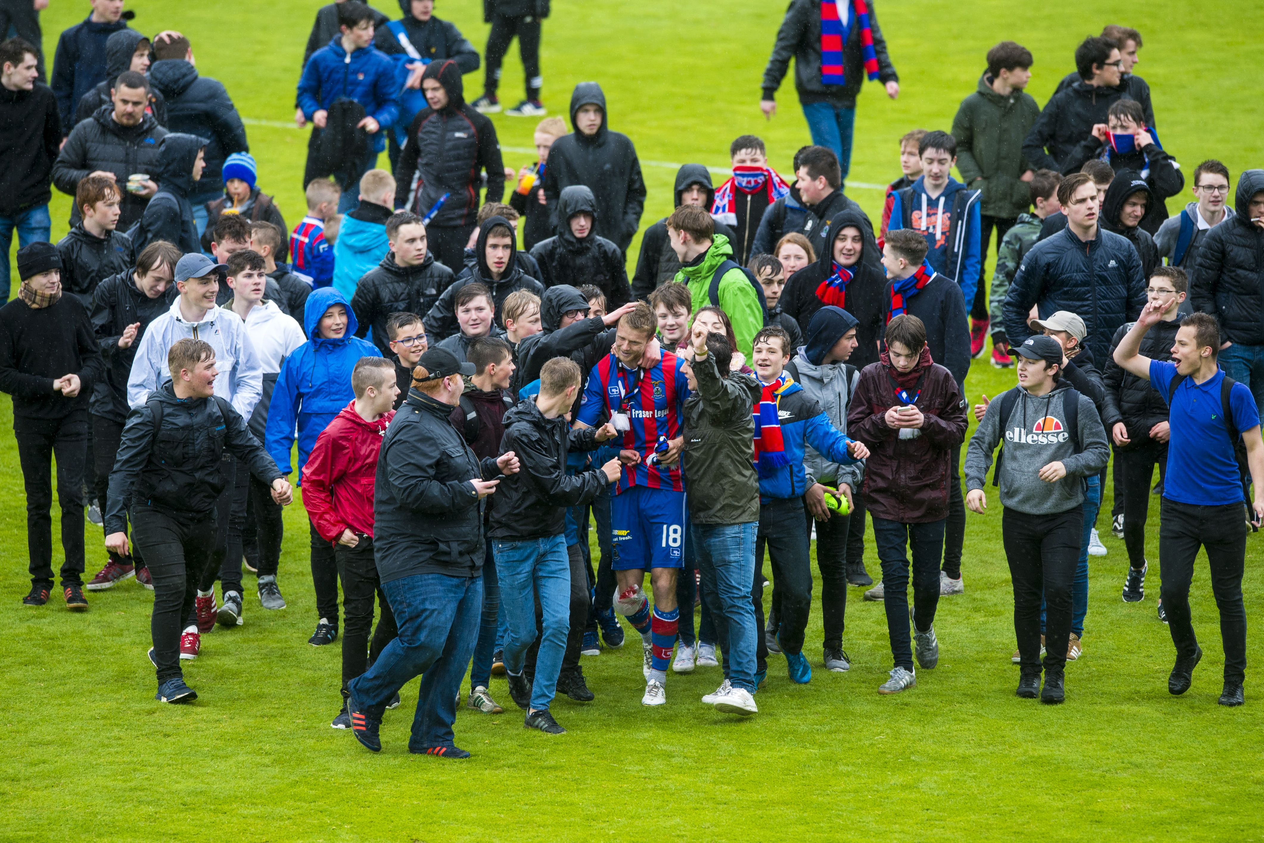 Alex Fisher is mobbed by Caley Thistle fans after their relegation.