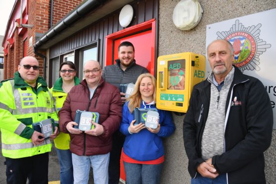 Members of the Fraserburgh and district community safety with the new defibrillators which were purchased after £9,000 in funding was secured.
L to R: Douglas Ewen, Colleen Ewen, Brian Noble, Chris Arnott, Claire Levett and chairman John Anderson.

PIC: Duncan Brown