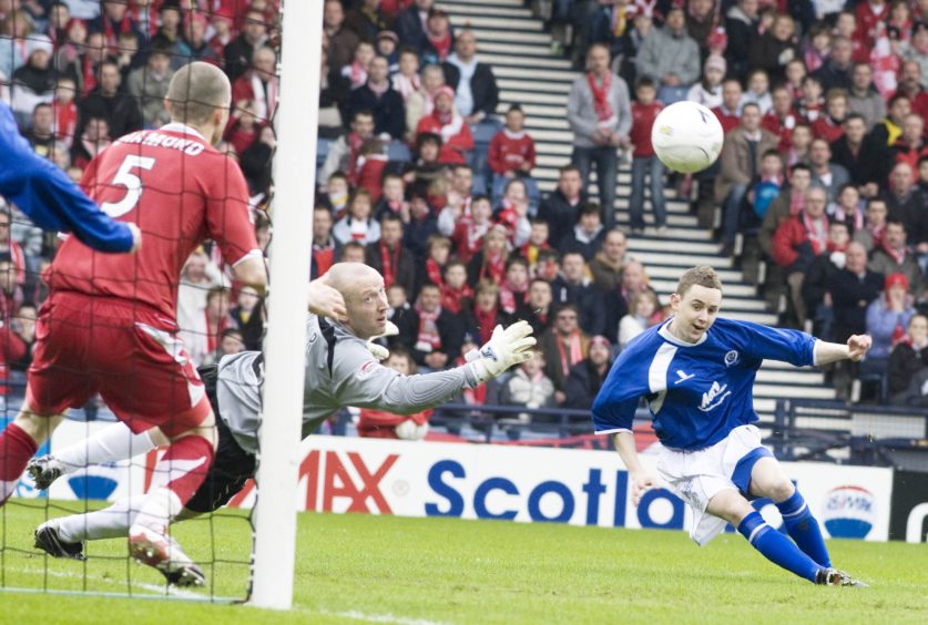 Paul Burns (right) fires the ball beyond Derek Soutar and Zander Diamond to put Queen of the South 2-1 up against Aberdeen