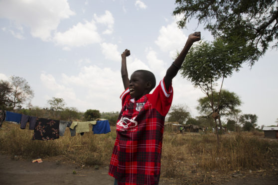 Edea Iren shows off the vintage Fraserburgh FC given to her during a Simon Murphy’s trip to Uganda