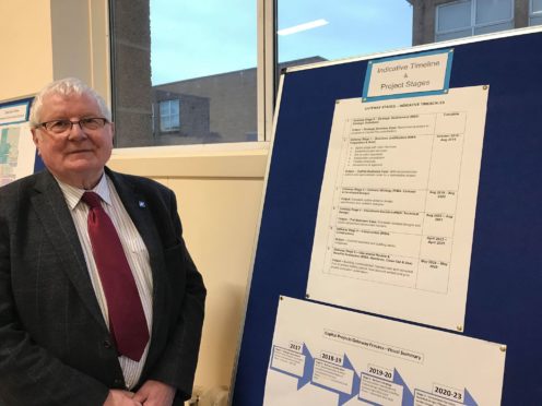 Councillor Norman Smith with the indicative time line of the Peterhead community campus.