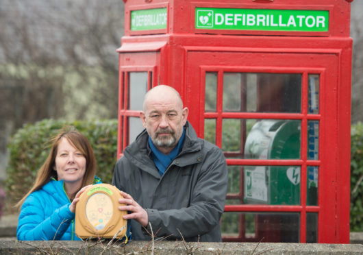 Sandra McKandie (chairwoman of Keiran's Legacy) and Roddy Robertson at Garmouth's new defibrillator telephone box.