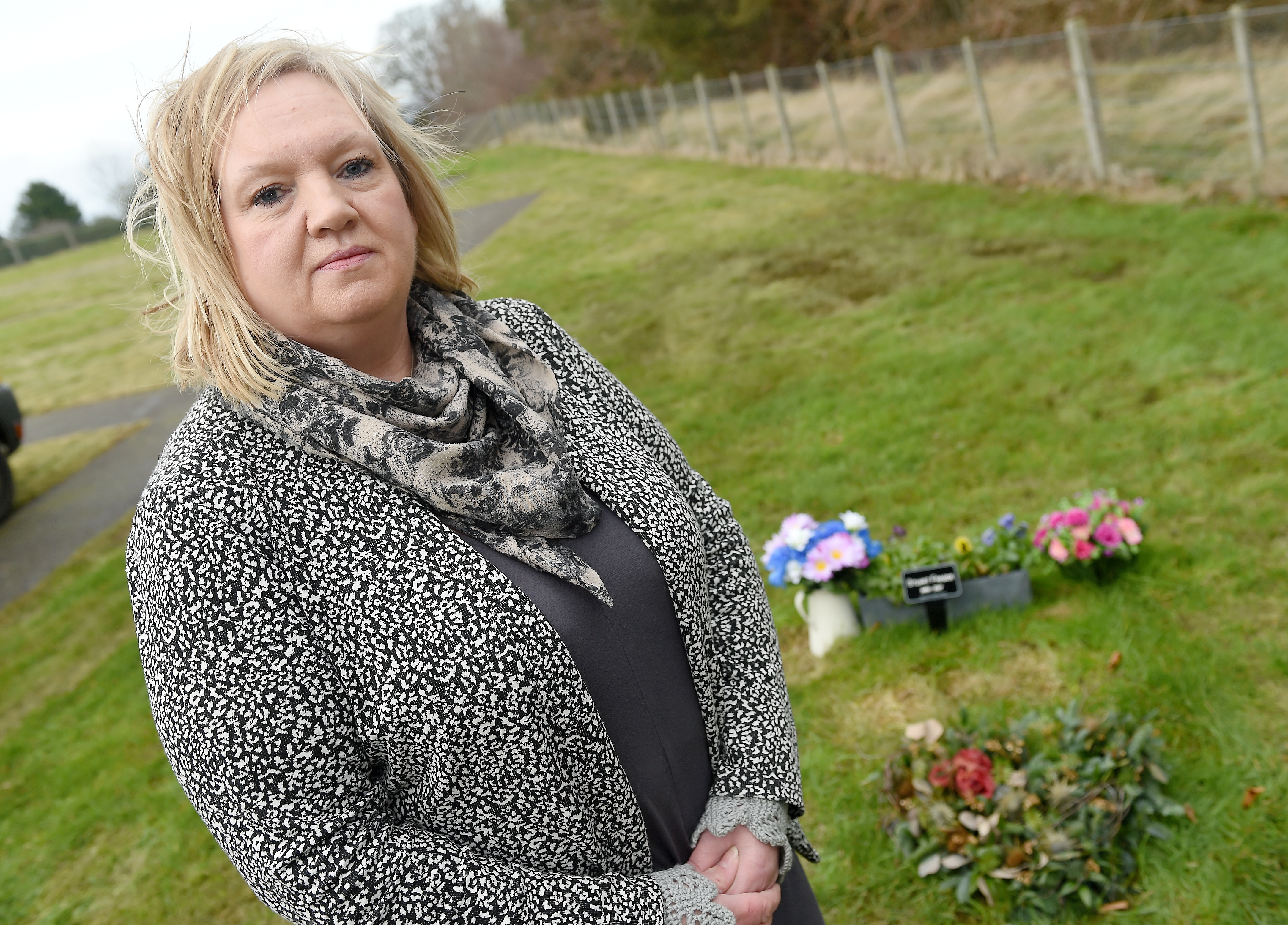 Lynda Fraser at the grave of her husband Stuart in Auldearn Cemetry, where a precious heart shaped wreath was removed by staff while tidying the graveyard of Christmas wreaths.