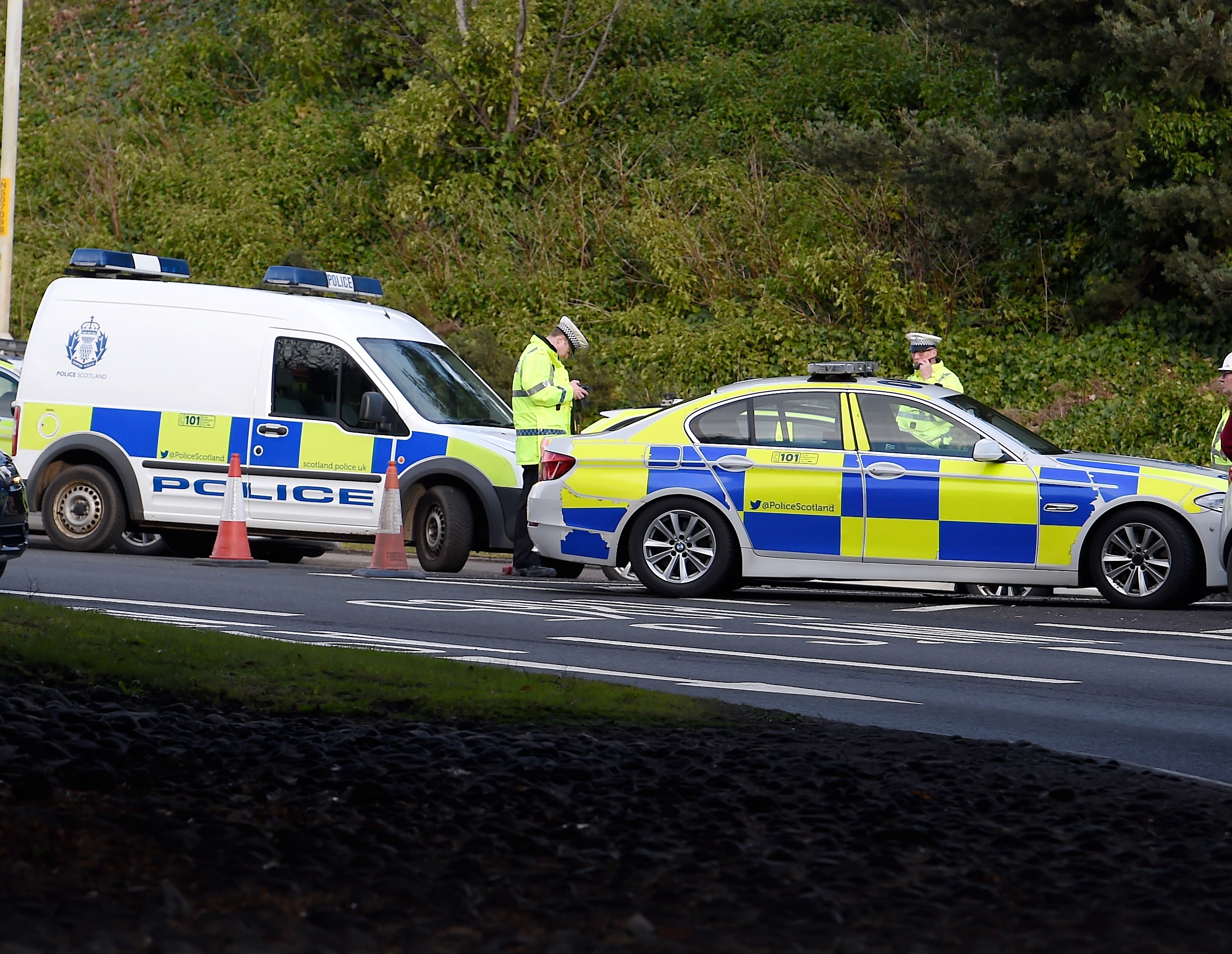 Police deal with the accident involving a car and a pedestrian at the Raigmore Interchange in Inverness. Picture by Sandy McCook.