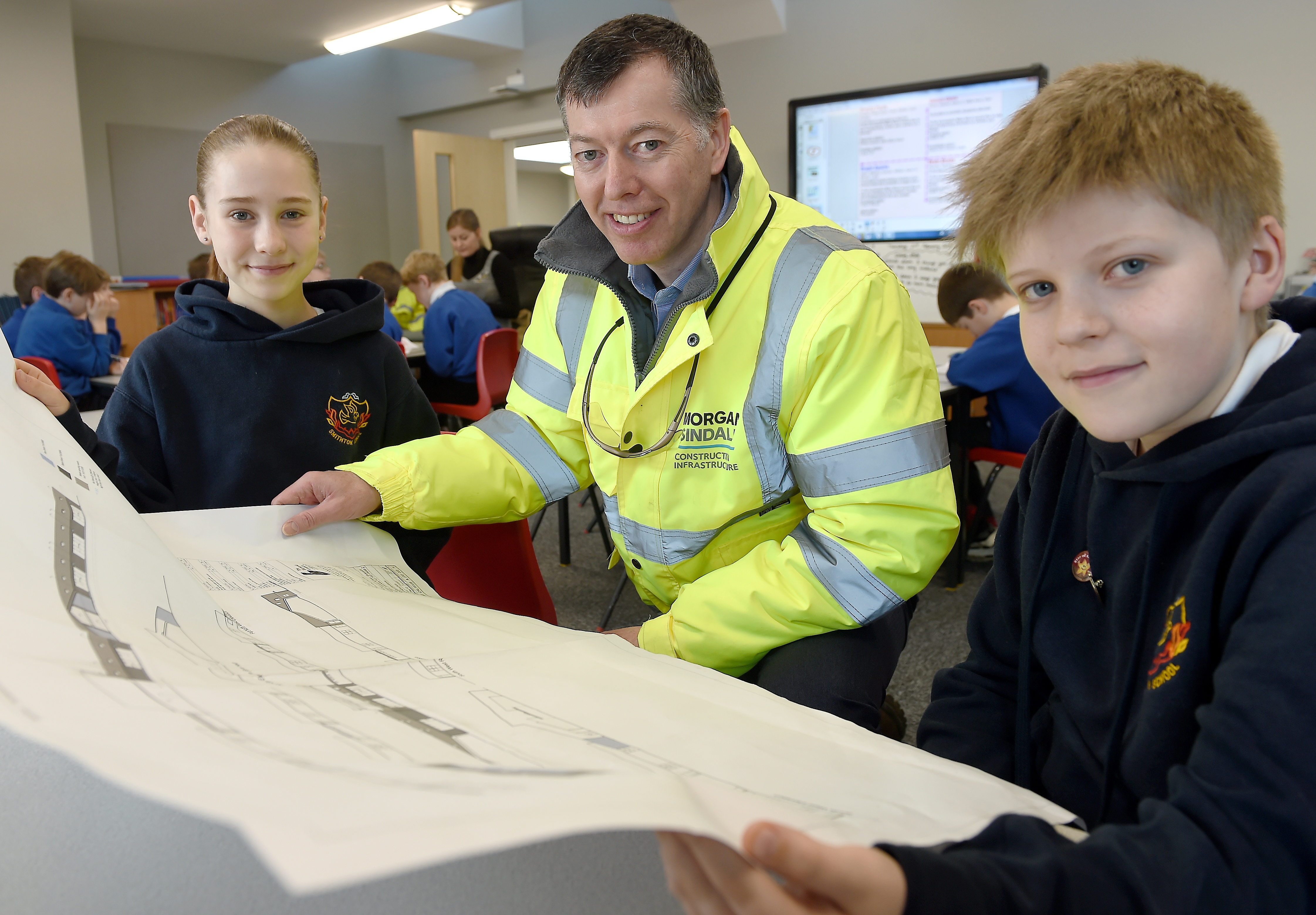 Ian MacDonald, Special Works Manager with contractors Morgan Sindal with pupils Martha Macintosh and Angus Smith both of Primary 7.