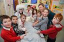 DR POTTY, MSP GILLIAN MARTIN AND THE DINKY DOCTORS OF MINTLAW PRIMARY NURSERY CLASS CHECK THE TEDDY FOR SIGNS OF LIFE.