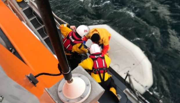 Ian Mackay being brought aboard the Buckie lifeboat.