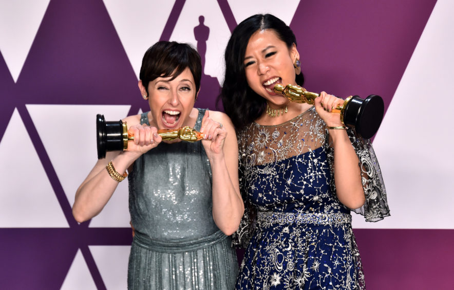 Becky Neiman-Cobb (left) and Domee She with the award for Best Animated Short Film for Bao.
