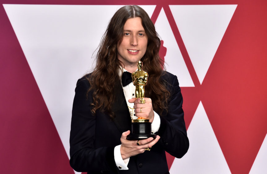 Ludwig Goransson with his award for Best Original Score for Black Panther.