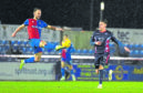 Inverness' Sean Welsh (L) competes with Ross County's Josh Mullins.