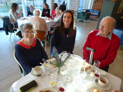 Student Jenna Scott with Contact the Elderly guests at a tea party hosted by the International School of Aberdeen