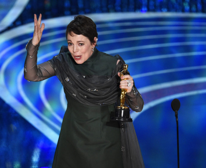 Olivia Colman reacts as she accepts the award for Best Actress In A Leading Role for The Favourite.