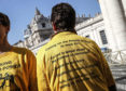 Demonstrators wear shirts as they stand outside St. Peter's Square on the day of the opening of a sex abuse within the Catholic church prevention summit, at the Vatican, Thursday, Feb. 21, 2019.  Pope Francis opened a landmark sex abuse prevention summit Thursday by warning senior Catholic figures that the faithful are demanding concrete action against predator priests and not just words of condemnation. (Giuseppe Lami/ANSA via AP)
