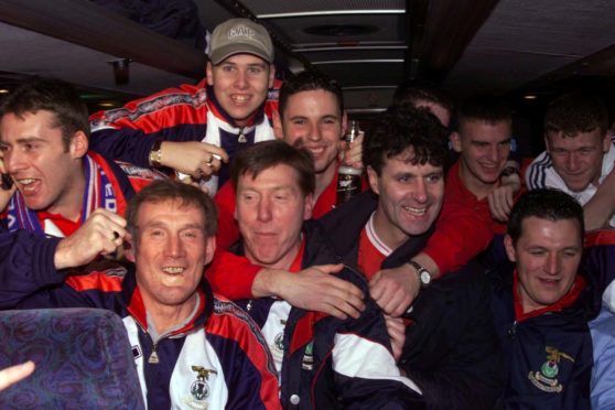 The Inverness players celebrate their victory with manage Steve Paterson on the team bus.