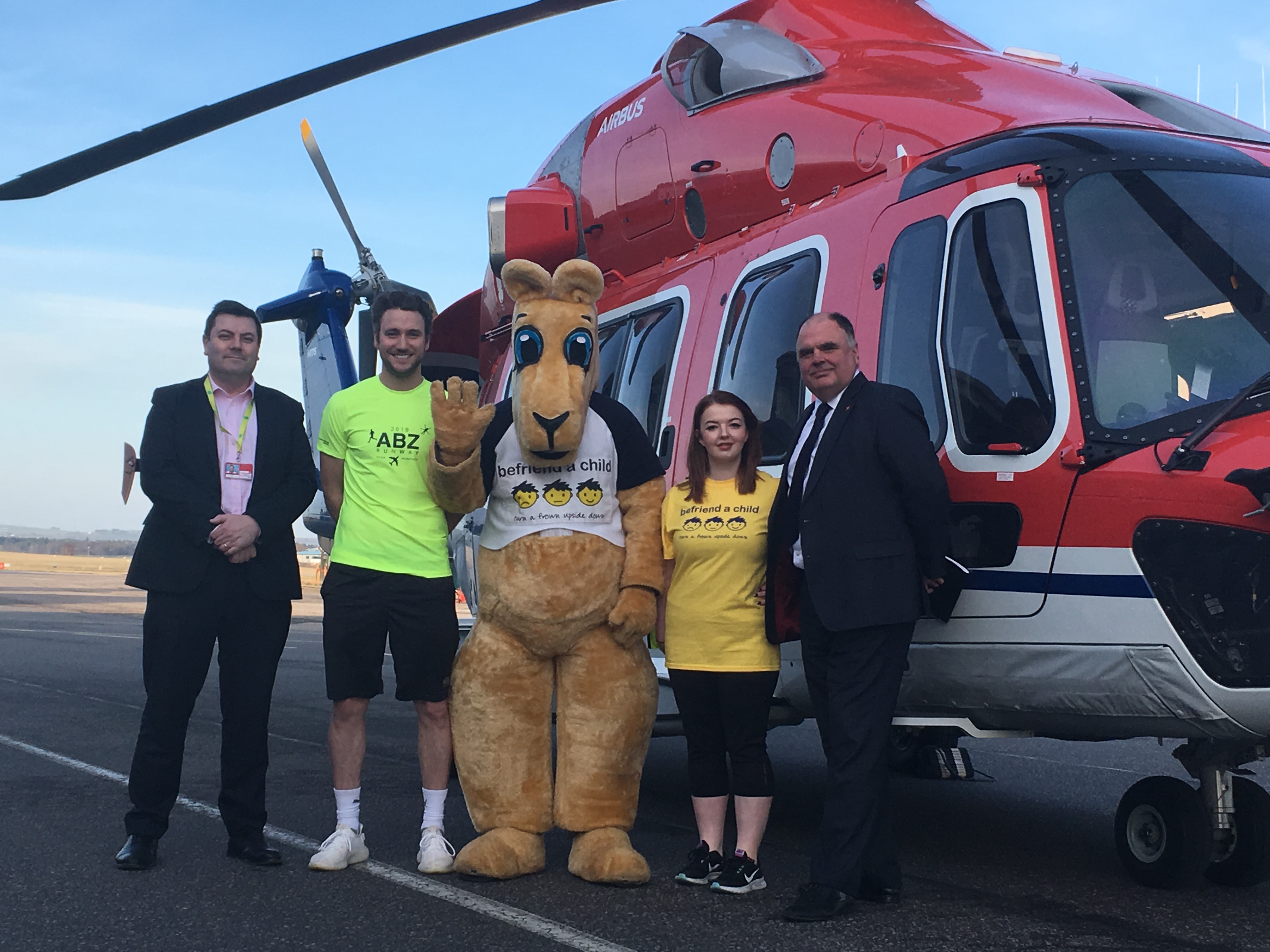 Steve Szalay from Aberdeen Airport, CHC Captain Ryan Broadhurst, Kuddles and Hannah Adams from Befriend a Child, and Mark Abbey from CHC.