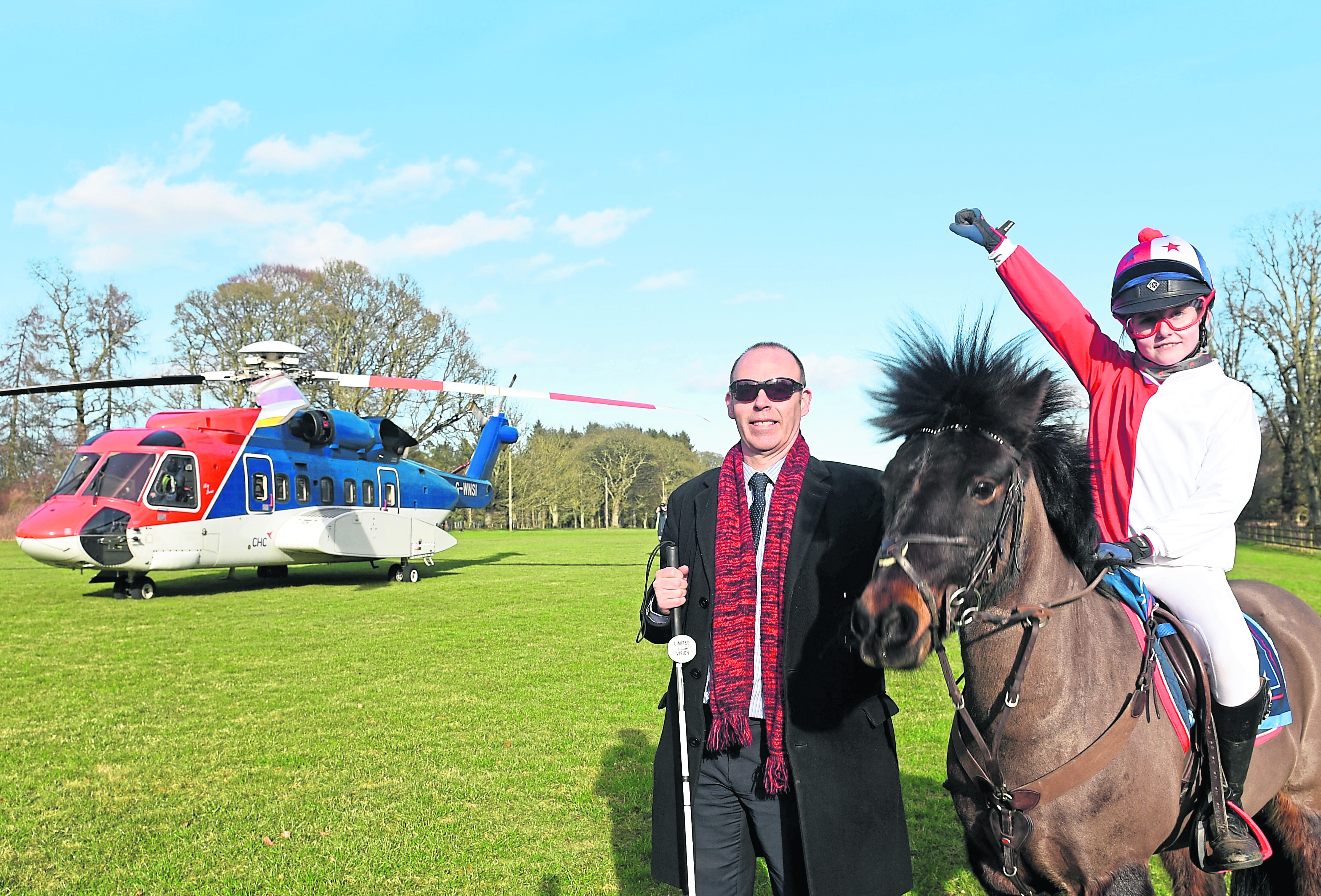 Pictured are Graham Findlay (NESS) and Millie Walker riding her pony - Cosmic Chaos at Fraser Castle. CHC is flying in a helicopter to Castle Fraser for its Day at the Races event to raise cash for North East Sensory Services (Ness).
Picture by Darrell Benns.