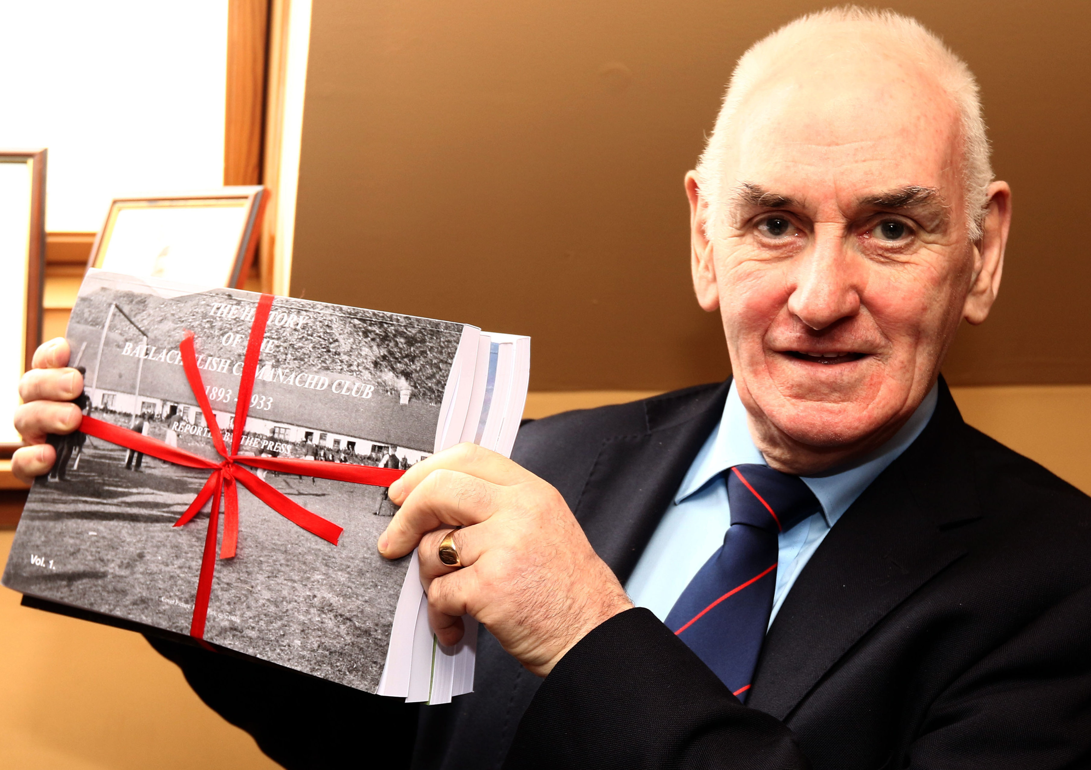 Ian MacPhee with the book he compiled telling the extensive 125 year history of Ballachulish Shinty Club. Picture by Kevin McGlynn