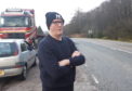 Phil Walker, near his home on the A82. His car was seriously damaged earlier this month on “crater” near to Glencoe.